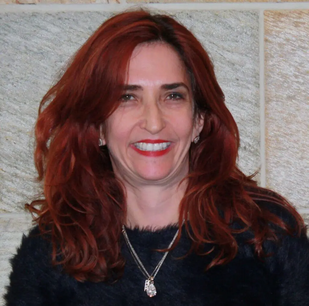 A woman with red hair and wearing a black shirt.