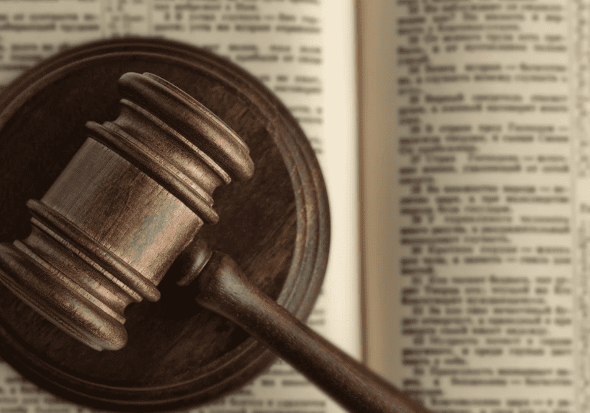 Gavel on open book, legal concept.